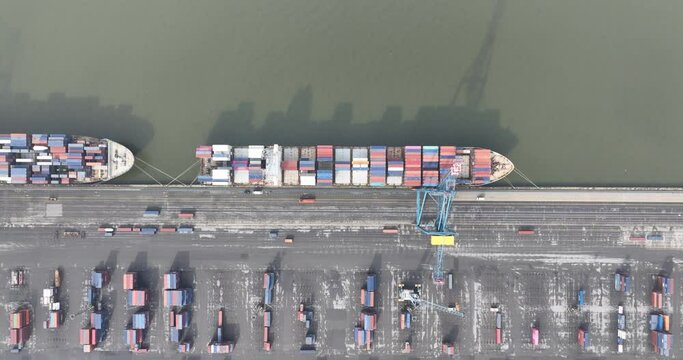 Aerial top down in the Port of Antwerpen, Belgium. A company that provides logistics. Port terminals for loading and unloading general cargo, breakbulk, containers, cars and others products.