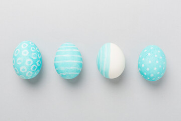 Blue easter eggs on color background, top view