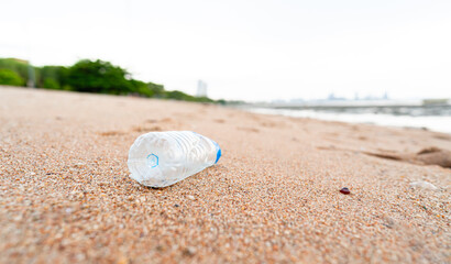 Close up view. Clear plastic bottles are trash on the beach. It shows the lack of conscience of...