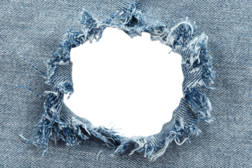 Hole in denim on a white background. Ripped jeans