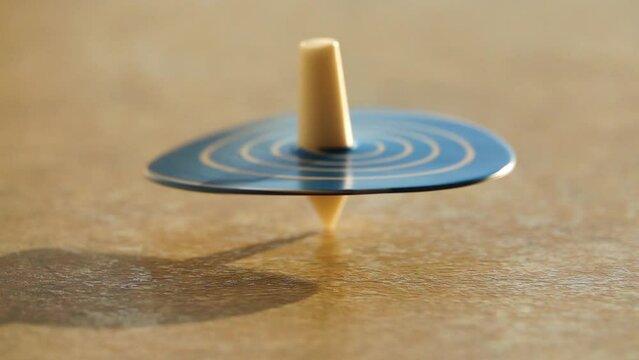 Blue round whirligig spins around her own axis on the table.