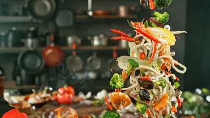 Freeze Motion of Wok Pan with Flying Asian Meal in the Air.