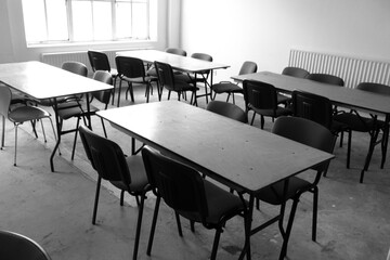 An Empty Desolate Classroom With Empty Desk and Seats