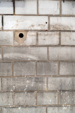 White Industrial Wall with Bricks and Stains and Dark Grouting