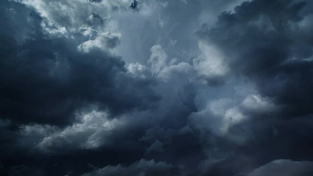 Storm clouds and lot of lightning during a thunderstorm. Dramatic clouds moving fast, 4k
