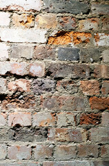 A Crumbling Indoor Vintage Brick Wall with Red Bricks