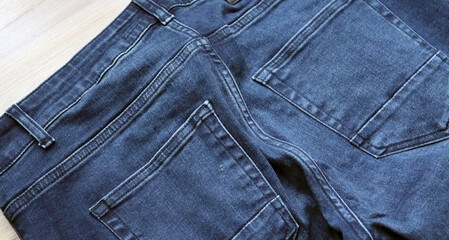 Blue jeans. Closeup of a stylish blue denim jeans. Top view - 750190101