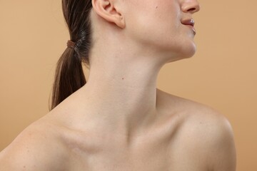 Beauty concept. Woman on beige background, closeup