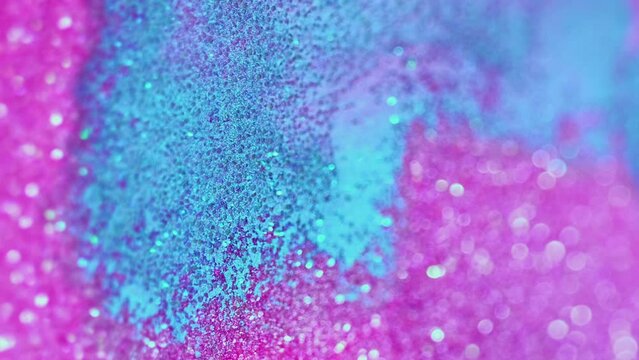 Vertical video. Abstract background. Sparkles fluid. Glitter bath. Glamorous hypnotic shiny aromatherapy blue and pink bomb dissolving spreading in spa water.
