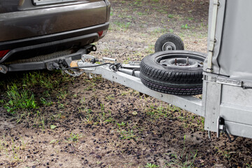 Tow hitch on a car. Trailer drawbar with spare wheel