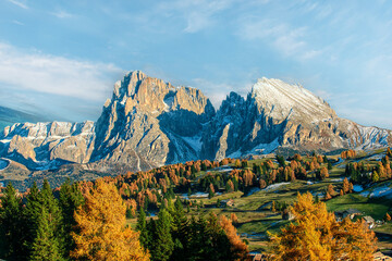 Autumn landscape with bright colors, house and larch trees in the soft sunlight. Dolomiti, Italy - 750199589
