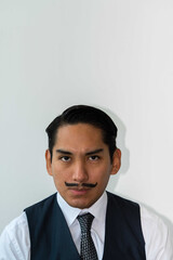 Eccentric Latin man with mustache posing on the white background