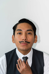Eccentric Latin man with mustache posing on the white background