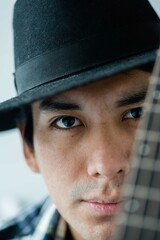Close up portrait of latin man with the guitar
