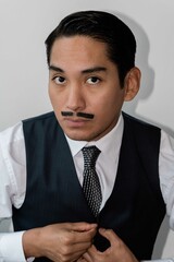 Latin man with drawn mustache headshot on white background