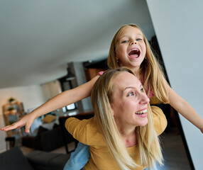 Fototapeta premium mother child daughter fun family woman girl happy together happiness teenager piggyback cheerful togetherness bonding parent love young joy
