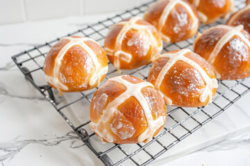 Hot cross buns arranged on a wire cooling rack. Generative AI
