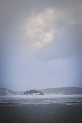 A lake is covered by ice in the middle of winter off Stockholm, Sweden. 
