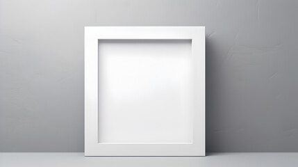 Fototapeta na wymiar mockup template poster: empty white square picture frame standing on desk behind clean grey wall background