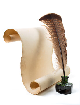 Ancient paper scroll with feather and ink bottle isolated on a white background