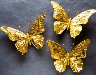 Golden butterflies made of foil on dark background. concept for jewelry store or beauty salon.