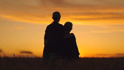 Mother, son hugging at sunset. Loving parent together with their child. Mom, child, son rejoicing,...