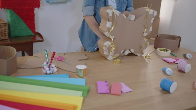 Craftswoman making handmade party decorations repurposing cardboard boxes 
