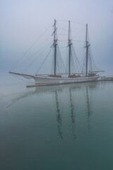A boat in morning fog on the Toronto harbour front at Lake Ontario in Ontario, Canada