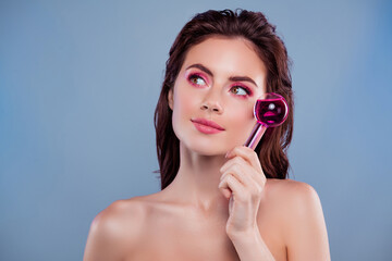 Portrait of gorgeous model girl hold cryotherapy serum bottle look empty space isolated on blue...