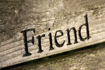 The word "Friend" engraved on wood..