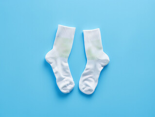 Two white socks on a blue background.