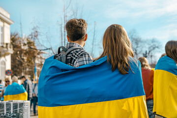Couple with Ukrainian flag at support rally