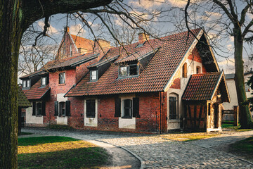 Street in the Baltic village. Old brick abandoned house in the traditional style