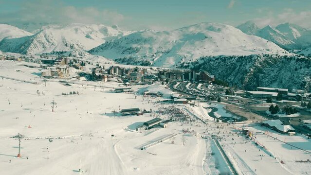 Aerial view of famous crowded Alpe d'Huez ski resort on a winter sunny day, France