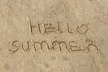 Fototapeta premium Inscription Hello Summer on the sand.Top view, flat lay. Sea vacation travel concept tourism and resorts. Summer holidays.