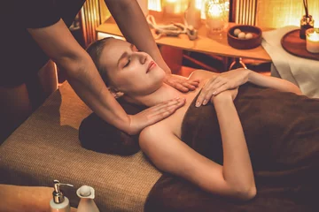 Tuinposter Caucasian woman customer enjoying relaxing anti-stress spa massage and pampering with beauty skin recreation leisure in warm candle lighting ambient salon spa at luxury resort or hotel. Quiescent © Summit Art Creations