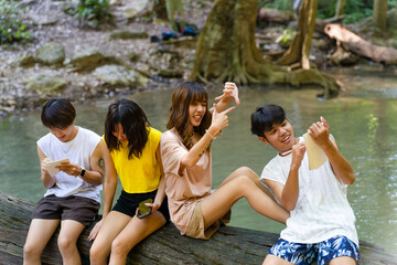 Group of Young Asian man and woman enjoy and fun outdoor lifestyle travel nature forest on summer...