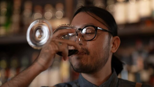 Night club concept of 4k Resolution. Bartender smiling confidently in a liquor store. A group of specialized clubs that sell alcoholic beverages.