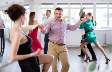 Pair of woman and man enjoying of contemporary boogie woogie dance in choreo class. Exciting hobby,...