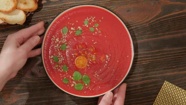 Presentation serving of tomato soup gazpacho puree top view.