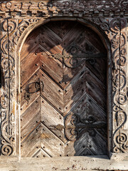 Ancient wooden carved door of the village house