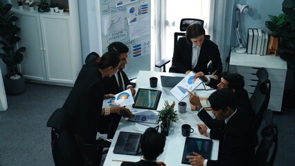 Top view of investor handed financial document to manager while explain marketing idea at meeting table. Diverse people looking at growing graph while listen business team discussion. Directorate. - obrazy, fototapety, plakaty