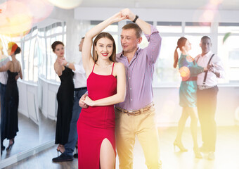 During rehearsal of reporting concert, man and woman participants of dance workshop perform figure...