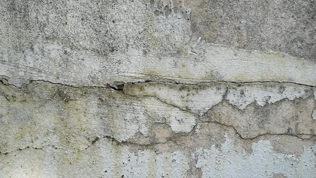Old concrete wall texture large crack and dirty wall surface with large damage.