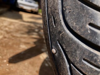 The motorbike tire is damaged. There is an air leak from the rubber. Because there are concrete nails in the tires.