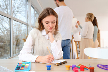 Female student drawing in art school