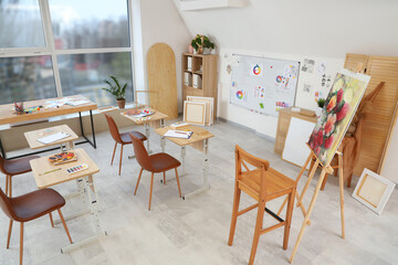 Interior of classroom with desks and whiteboard in art school