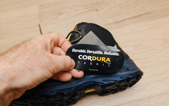 Hamburg, Germany - Feb 16, 2022: Reading about Cordura Fabric on the new Safety shoes S3 HRO WR SRC Hydro Modytex high black - durable, versatile and reliable