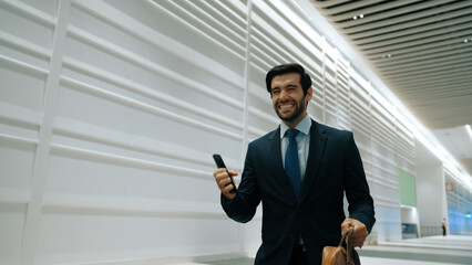 Happy business man celebrate his successful project while walking at white corridor. Project...