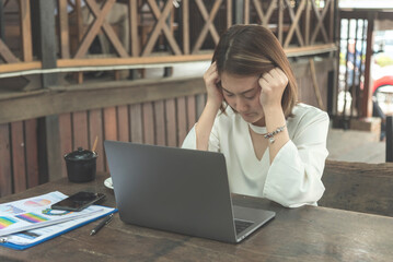 Recession Stress Woman using laptop work hard at home office headache, depressed from failure...